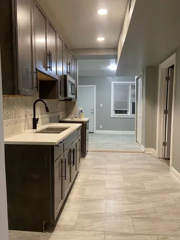 a kitchen with stainless steel appliances granite countertop a sink and a stove