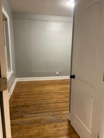 a view of room with wooden floor