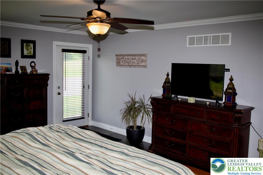 101 Cider Mill Road Mertztown, PA 19539 - Photo 20 of 26 a bedroom with a bed and a flat screen tv