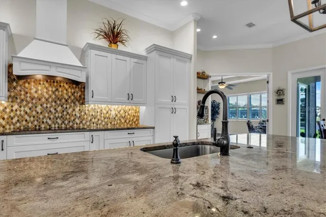 a bathroom with a granite countertop sink a toilet and a mirror