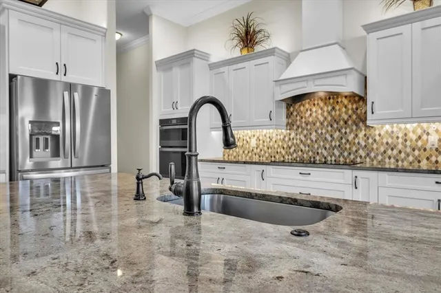 a bathroom with a granite countertop sink a toilet and a mirror