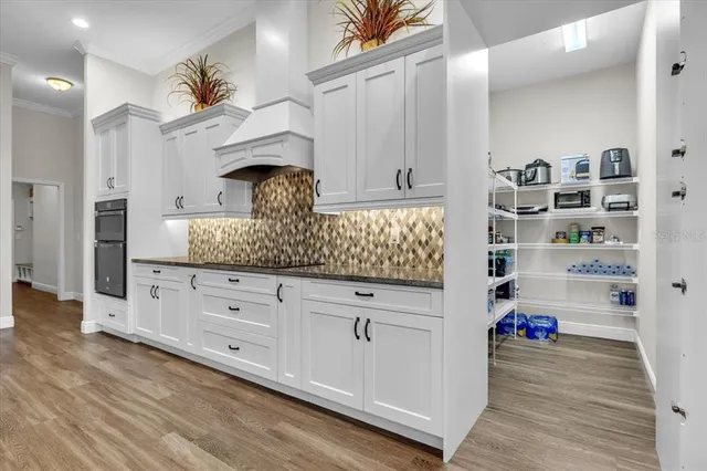 a bathroom with a granite countertop sink a mirror and shower
