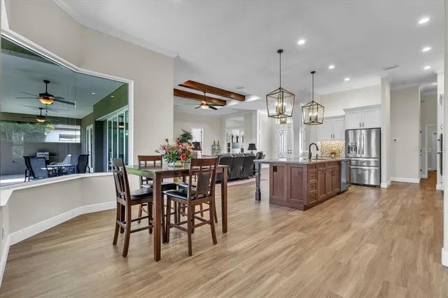 a view of a patio with a table chairs and a yard