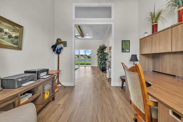 a view of a livingroom with workspace and a window