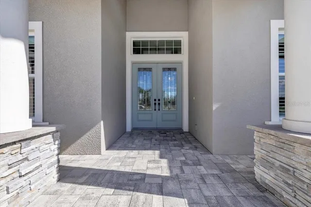 a kitchen with stainless steel appliances granite countertop a stove oven a dining table and chairs with wooden floor