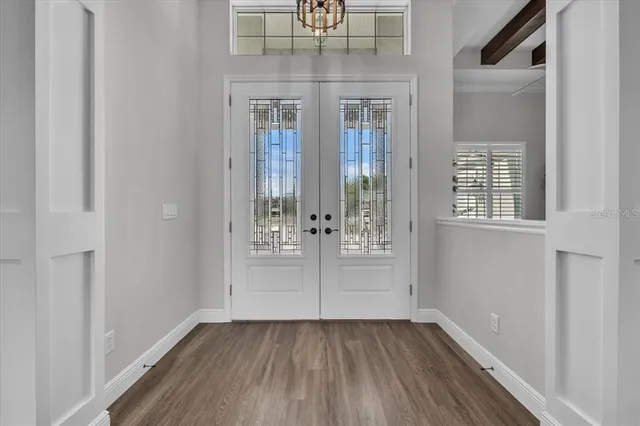 a kitchen with stainless steel appliances kitchen island granite countertop a refrigerator and a sink