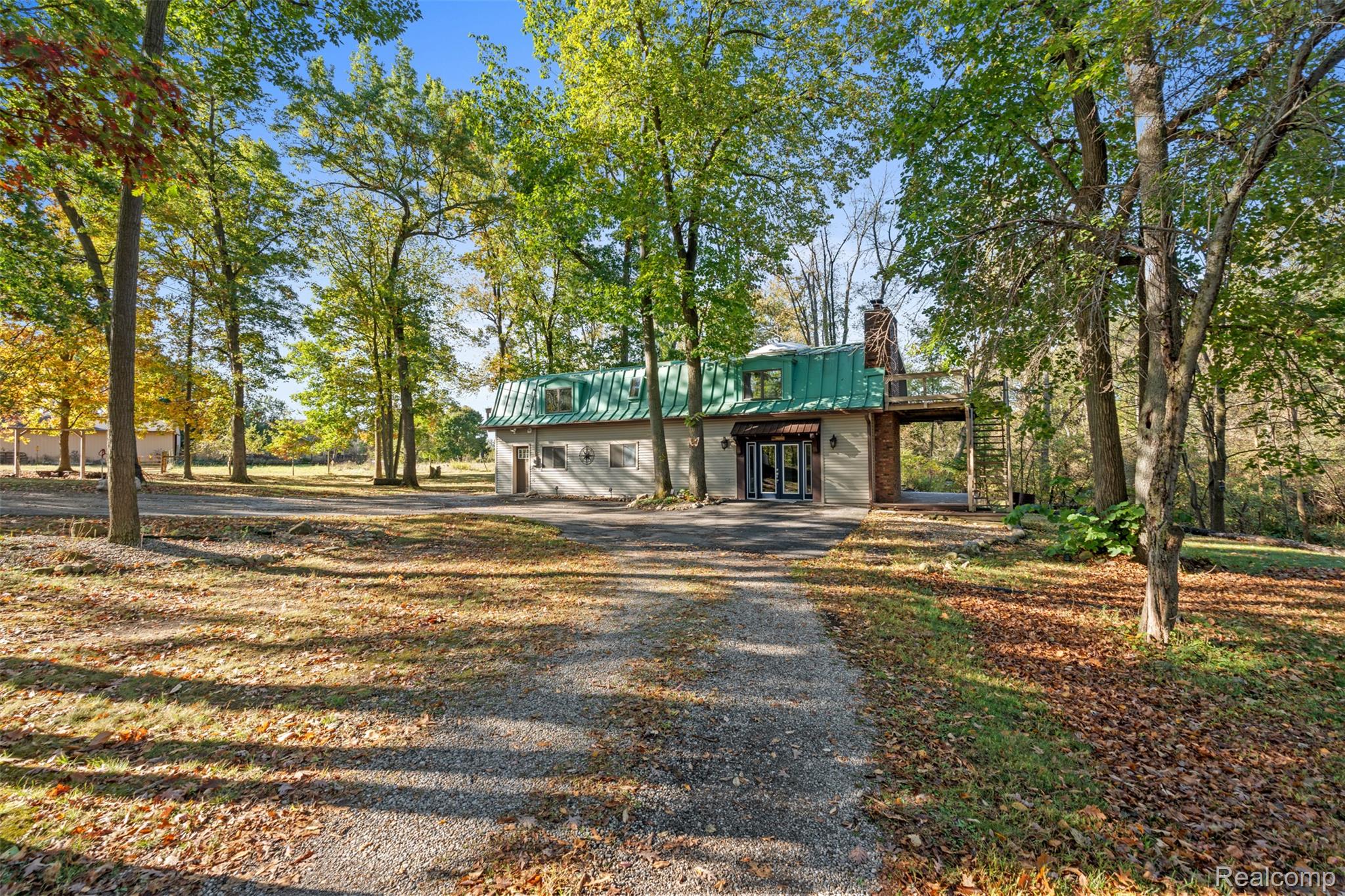 7670 Mi State Road Manchester, MI 48158 - Photo 3 of 53 View of front of house featuring driveway, a metal roof, a chimney, and french doors