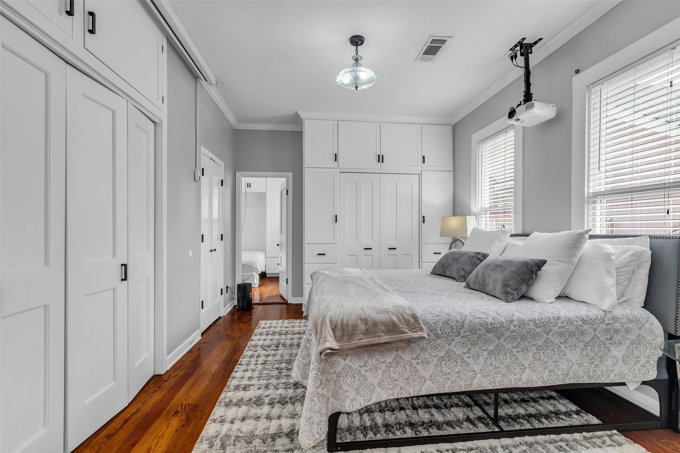 618 Harvard Street Houston, TX 77007 - Photo 18 of 25 a bed room with a bed and a chandelier