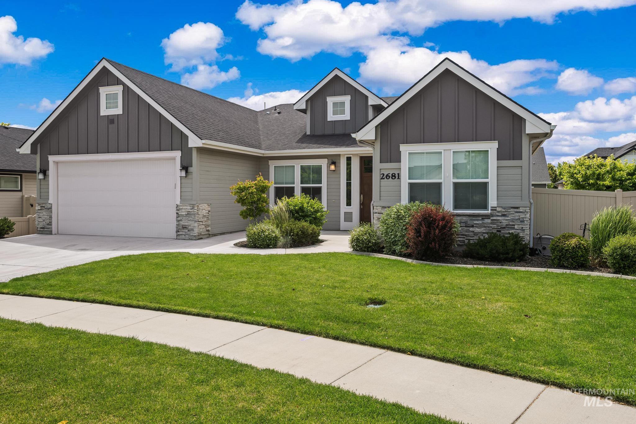 2681 East Rhyolite Court Nampa, ID 83686 - Photo 3 of 48 Contemporary exterior featuring horizontal siding, vertical board and batten accents, and stone veneer detailing
