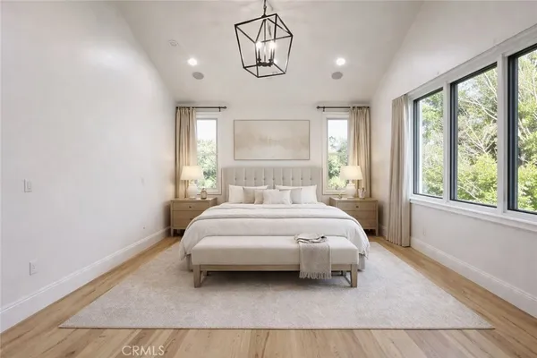 a bedroom with a bed lamp and window