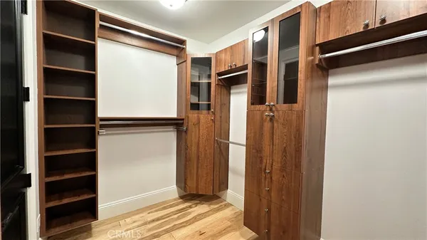 a view of walk in closet with empty racks