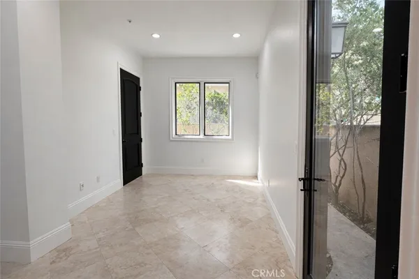 a view of an empty room and a window