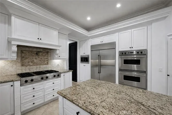 a kitchen with granite countertop cabinets and steel stainless steel appliances