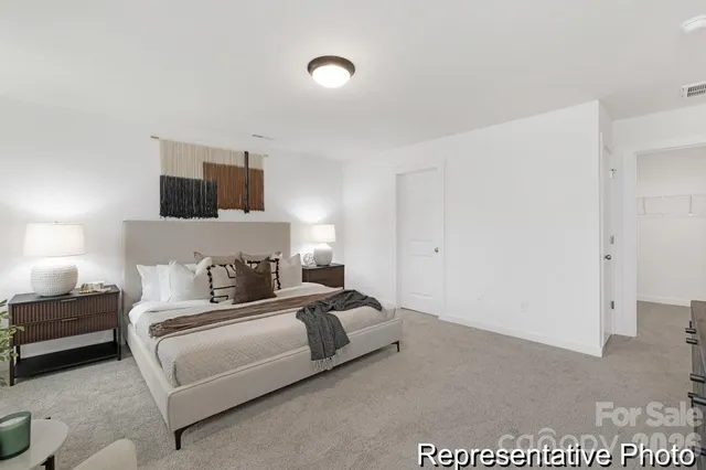 a bedroom with a bed and a television