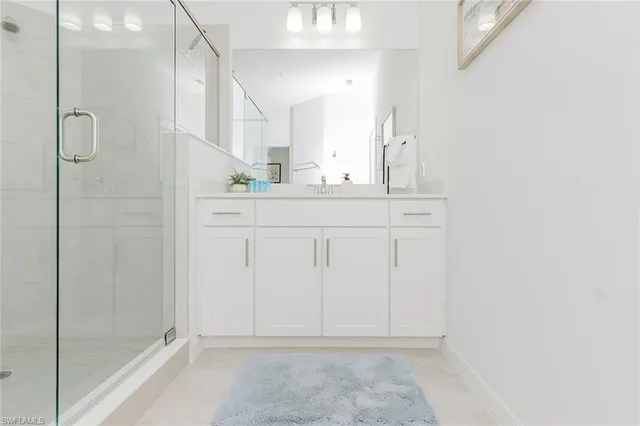 a bathroom with a shower sink and mirror