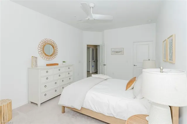 a spacious bedroom with a bed and a cabinets