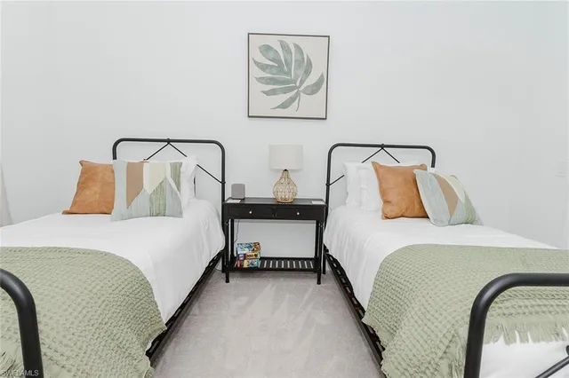 a bedroom with a bed and painting on the wall