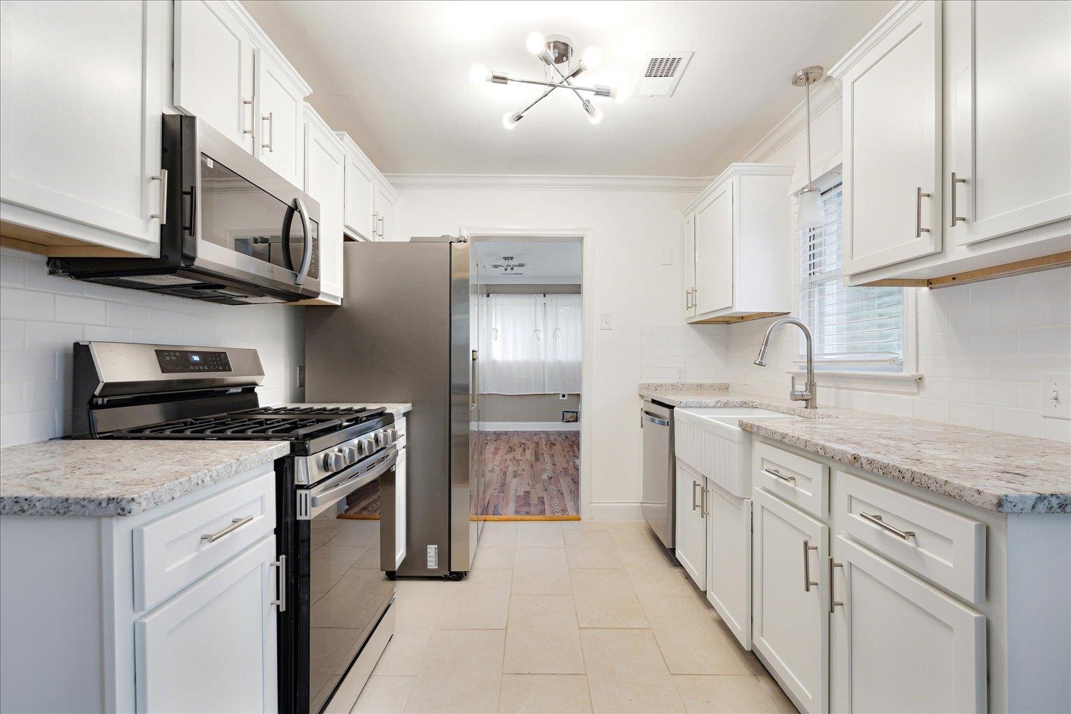 774 Eastern Drive Memphis, TN 38122 - Photo 11 of 33 a kitchen with stainless steel appliances granite countertop a refrigerator and a stove