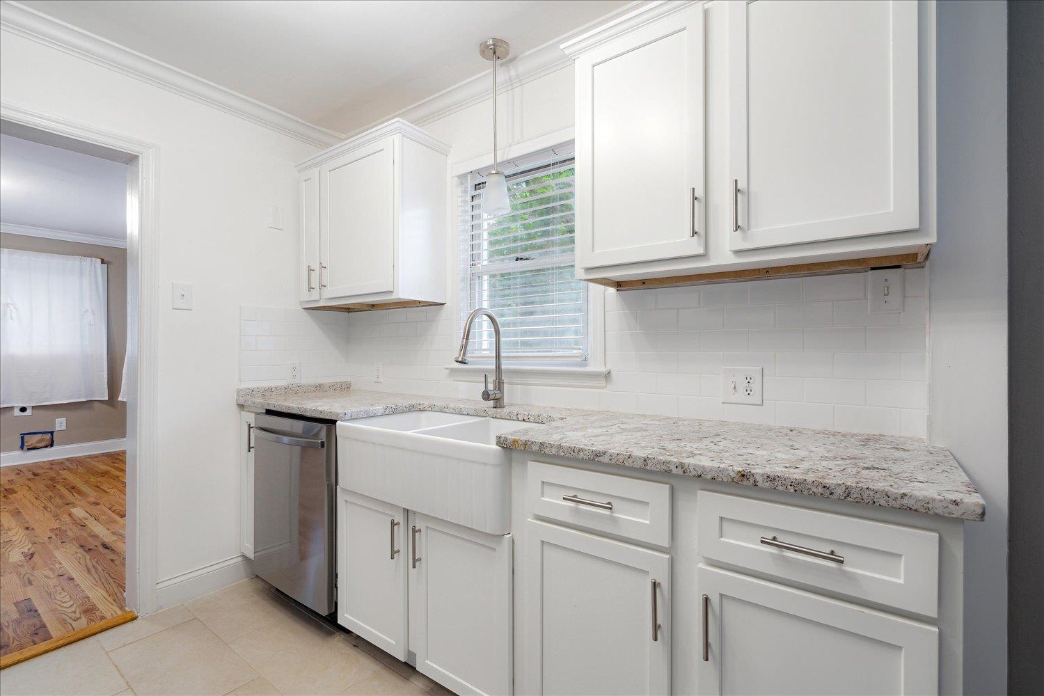 774 Eastern Drive Memphis, TN 38122 - Photo 12 of 33 a kitchen with granite countertop white cabinets and a sink
