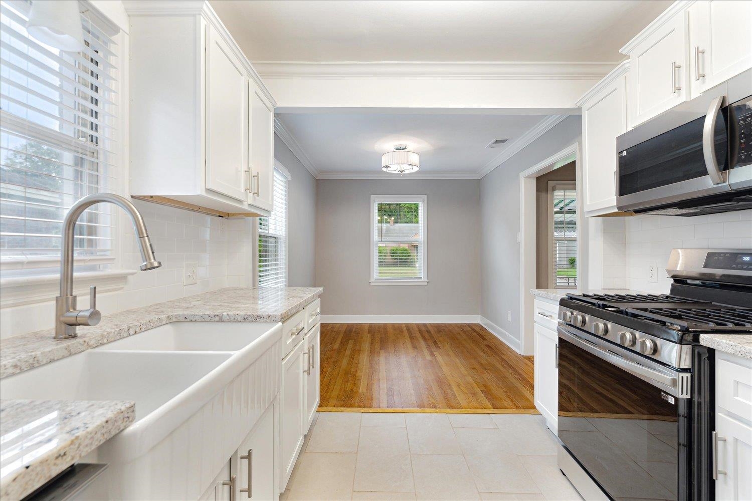 774 Eastern Drive Memphis, TN 38122 - Photo 14 of 33 a kitchen with stainless steel appliances granite countertop a sink a stove and a microwave