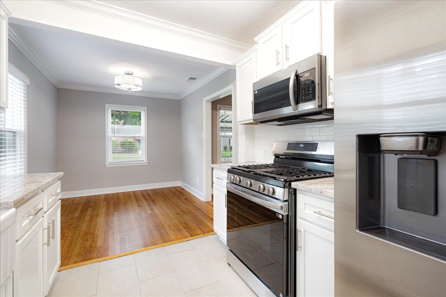 774 Eastern Drive Memphis, TN 38122 - Photo 15 of 33 a kitchen with stainless steel appliances granite countertop a stove and a microwave