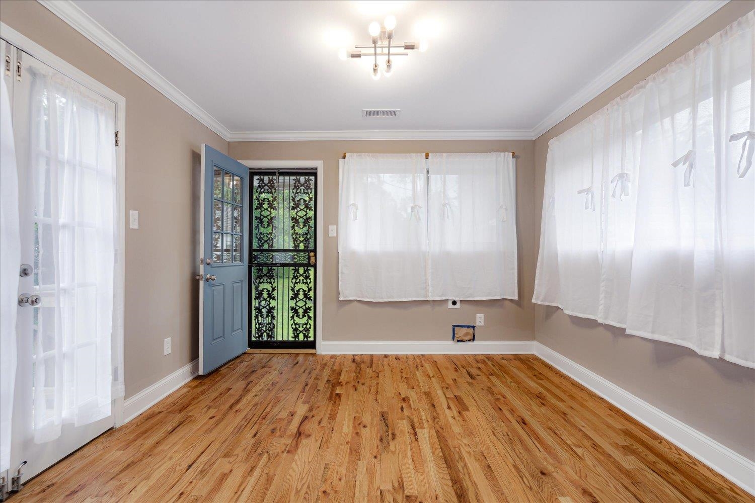 774 Eastern Drive Memphis, TN 38122 - Photo 16 of 33 an empty room with wooden floor and windows