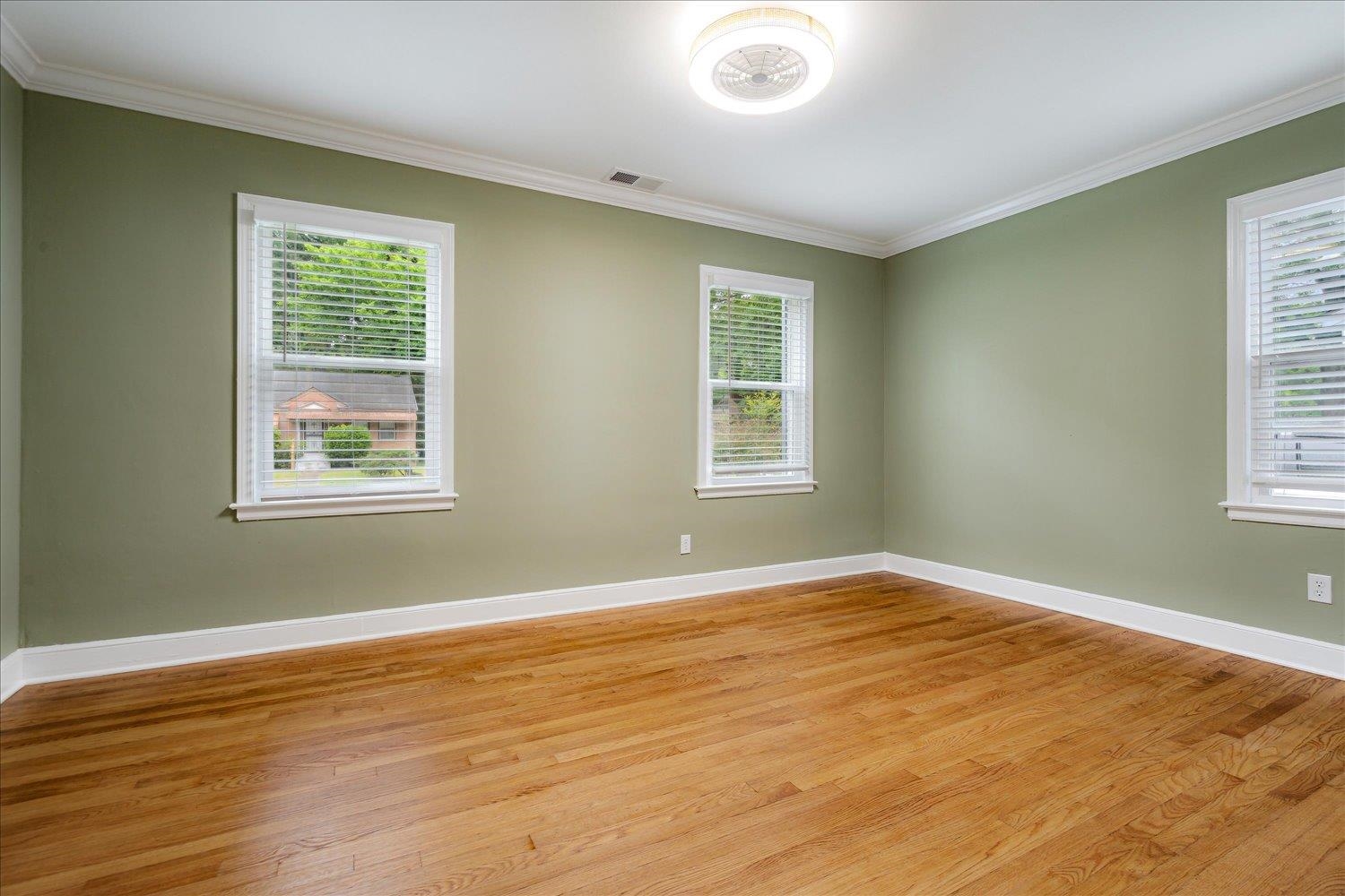 774 Eastern Drive Memphis, TN 38122 - Photo 23 of 33 a view of an empty room with wooden floor and a window