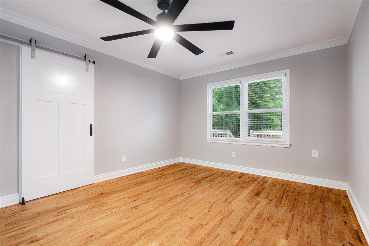 774 Eastern Drive Memphis, TN 38122 - Photo 6 of 33 a view of empty room with wooden floor and fan
