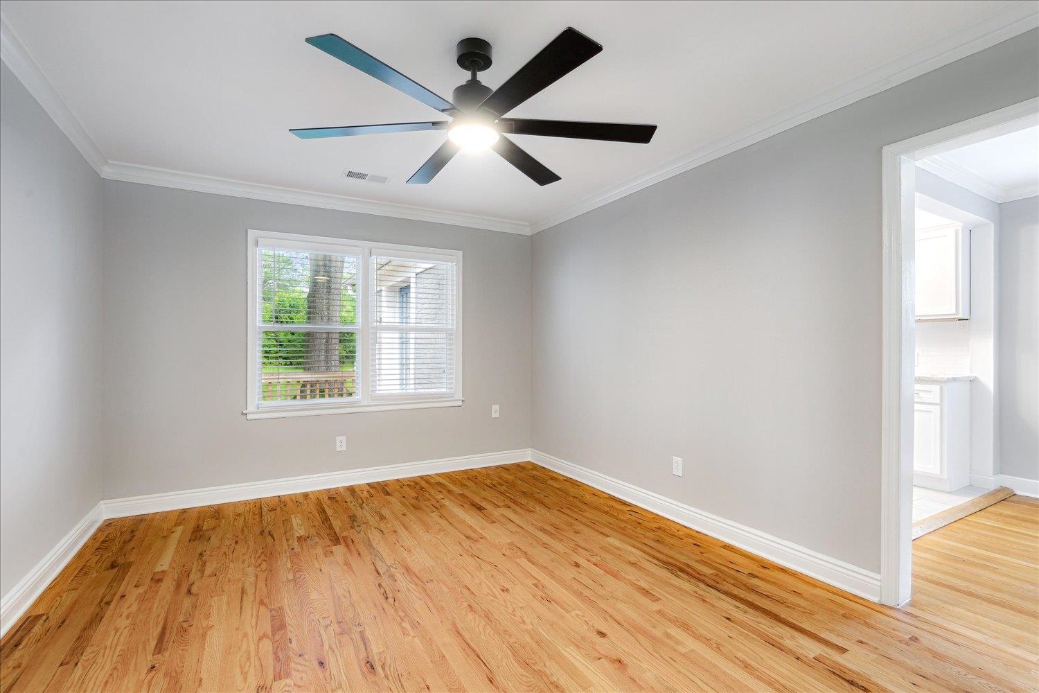 774 Eastern Drive Memphis, TN 38122 - Photo 7 of 33 an empty room with wooden floor and windows