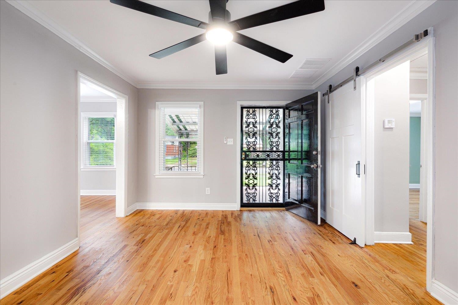 774 Eastern Drive Memphis, TN 38122 - Photo 8 of 33 a view of an empty room with wooden floor and a window