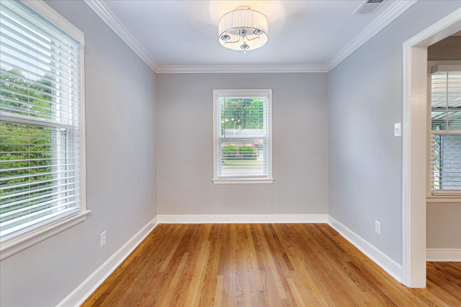 774 Eastern Drive Memphis, TN 38122 - Photo 10 of 33 a view of an empty room with wooden floor and a window