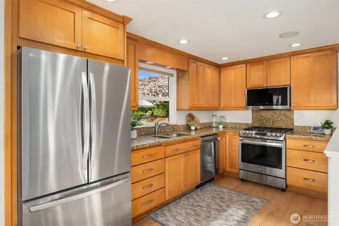 a kitchen with sink a window and potted plant