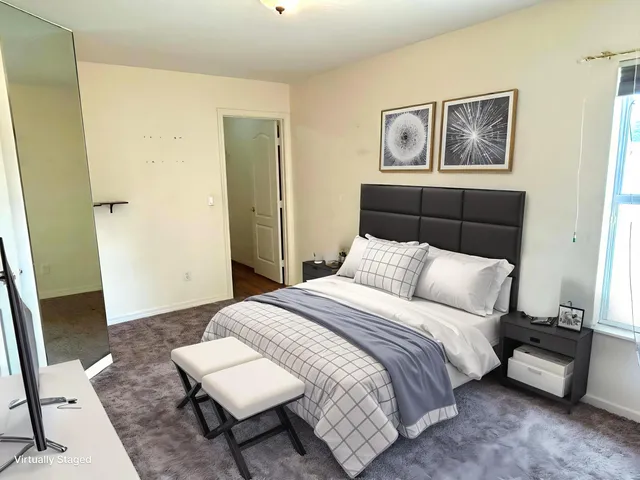 a bedroom with a bed and a couch