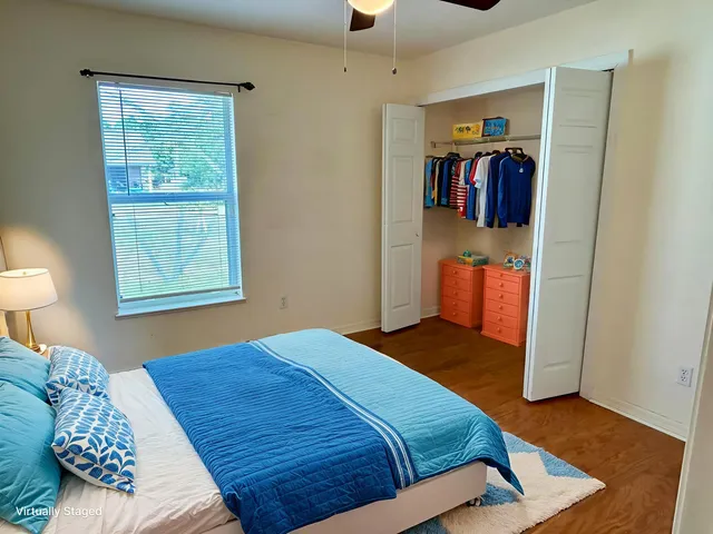 a bedroom with a bed and a window