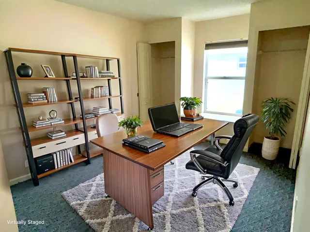 a workspace with furniture and window
