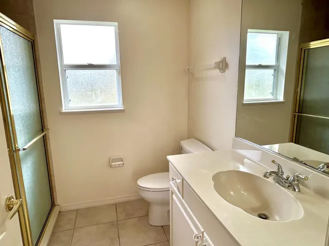 a bathroom with a sink toilet and mirror