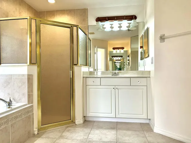 a bathroom with a double vanity sink and a mirror