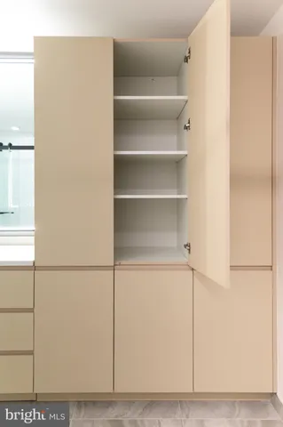 a view of an empty walk in closet with wooden floor