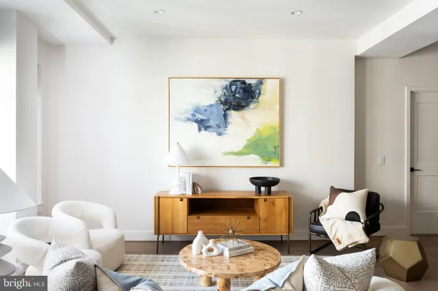 a living room with furniture and a lamp