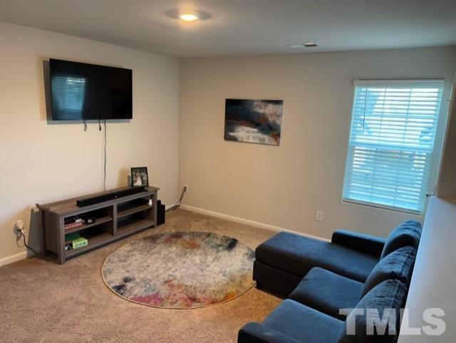 324 Rustling Way Zebulon, NC 27597 - Photo 3 of 3 a room with furniture and a flat screen tv