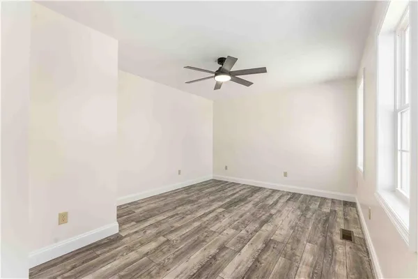 a view of room with a ceiling fan and window