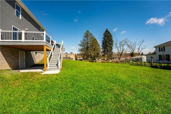 a front view of a house with a yard and trees