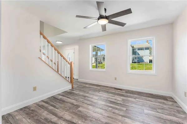 wooden floor in an empty room with a window