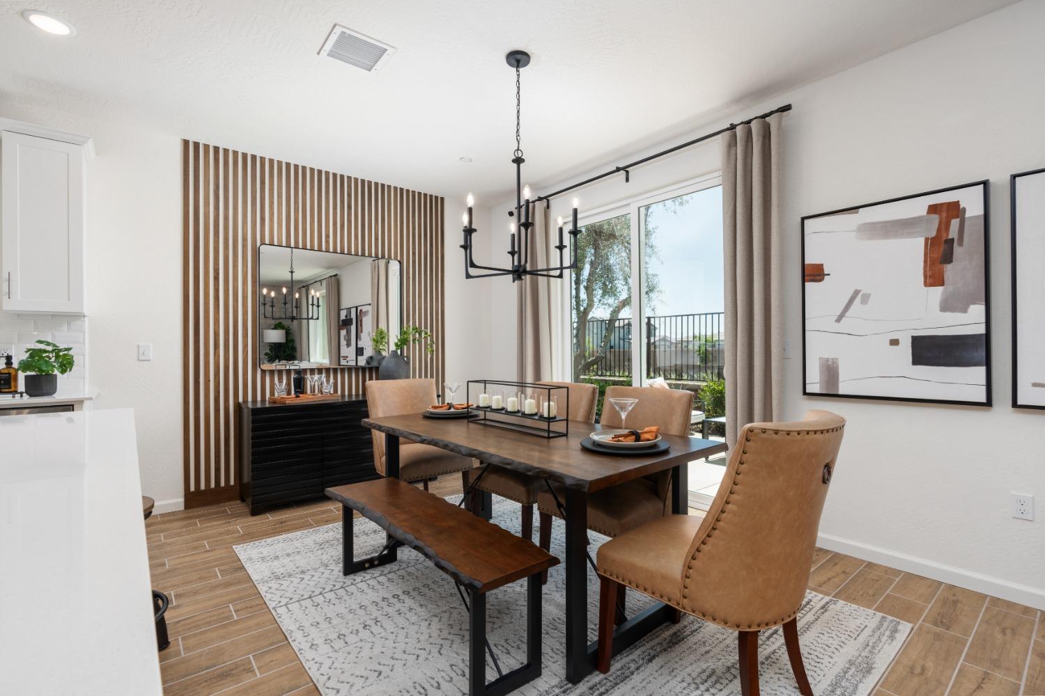 1601 Bloom Avenue Clovis, CA 93619 - Photo 12 of 28 a dining room with furniture a chandelier and wooden floor