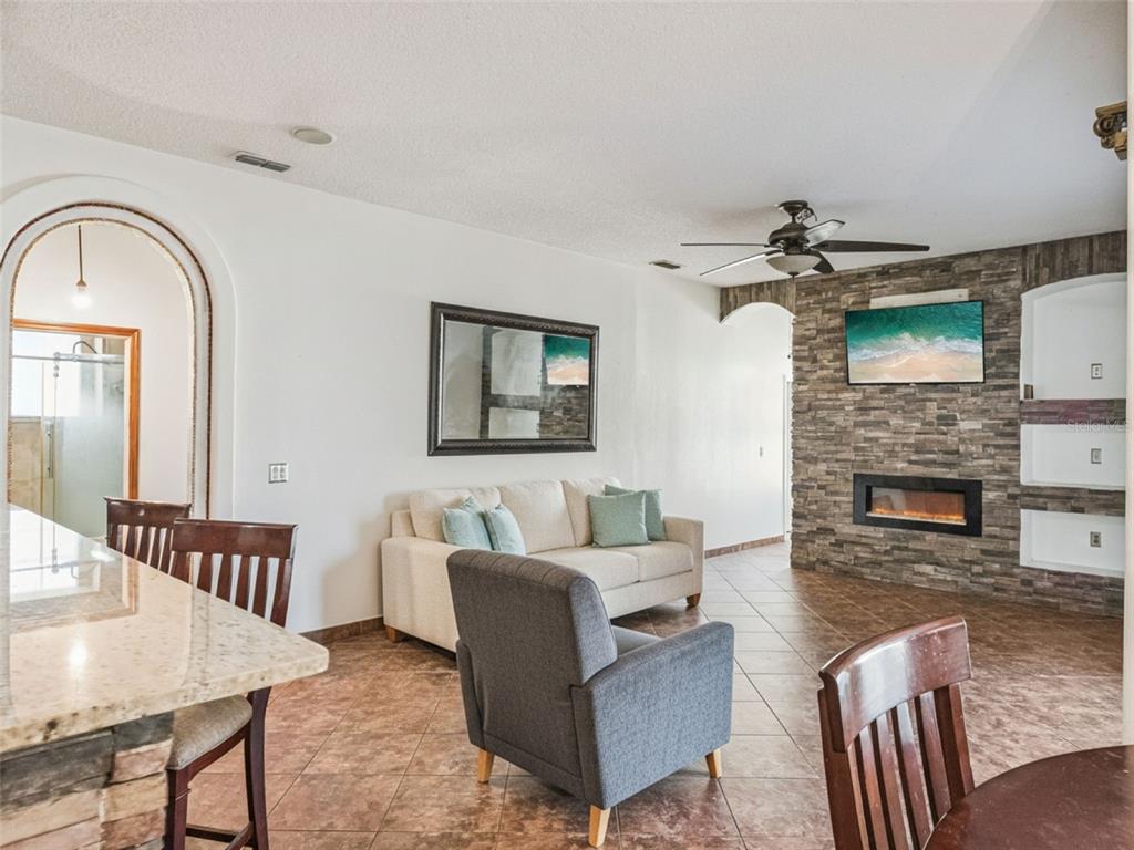 9101 Lake Coventry Court Gotha, FL 34734 - Photo 11 of 45 a living room with furniture and a fireplace