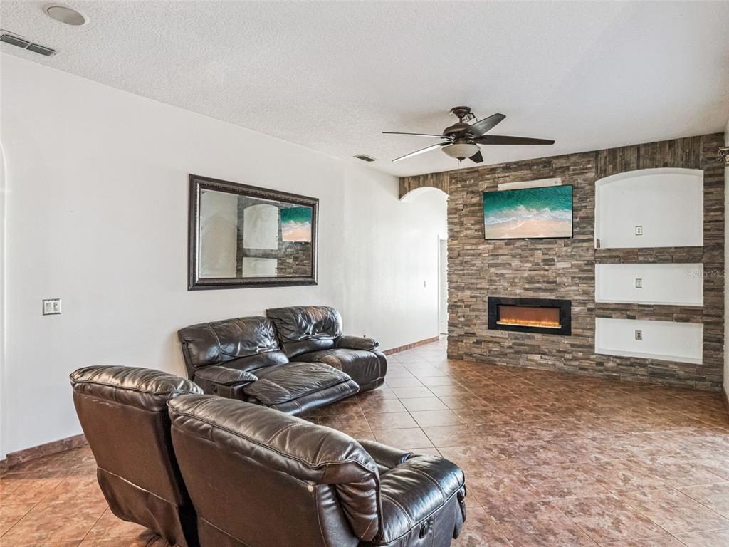 9101 Lake Coventry Court Gotha, FL 34734 - Photo 12 of 45 a living room with furniture and a fireplace