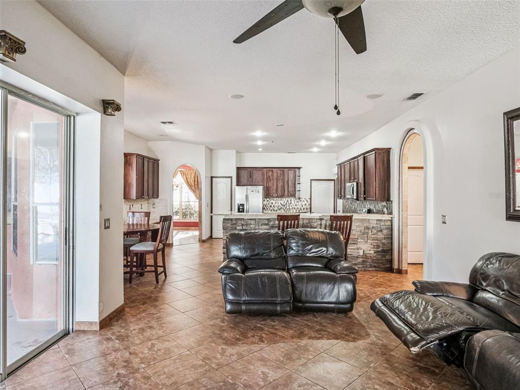 9101 Lake Coventry Court Gotha, FL 34734 - Photo 15 of 45 a living room with furniture kitchen view and a refrigerator