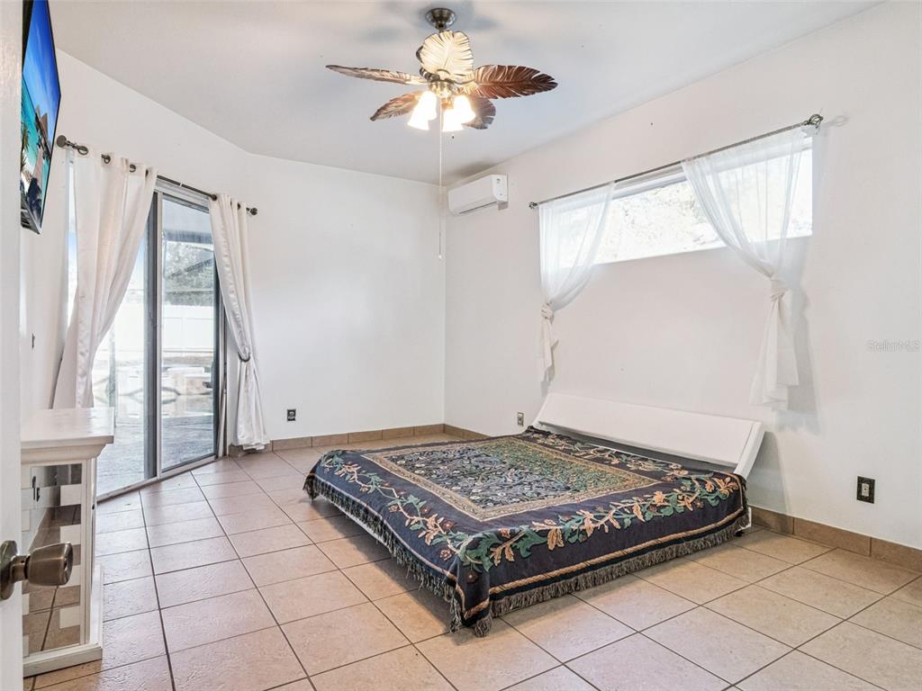 9101 Lake Coventry Court Gotha, FL 34734 - Photo 17 of 45 a bedroom with a bed and a chandelier