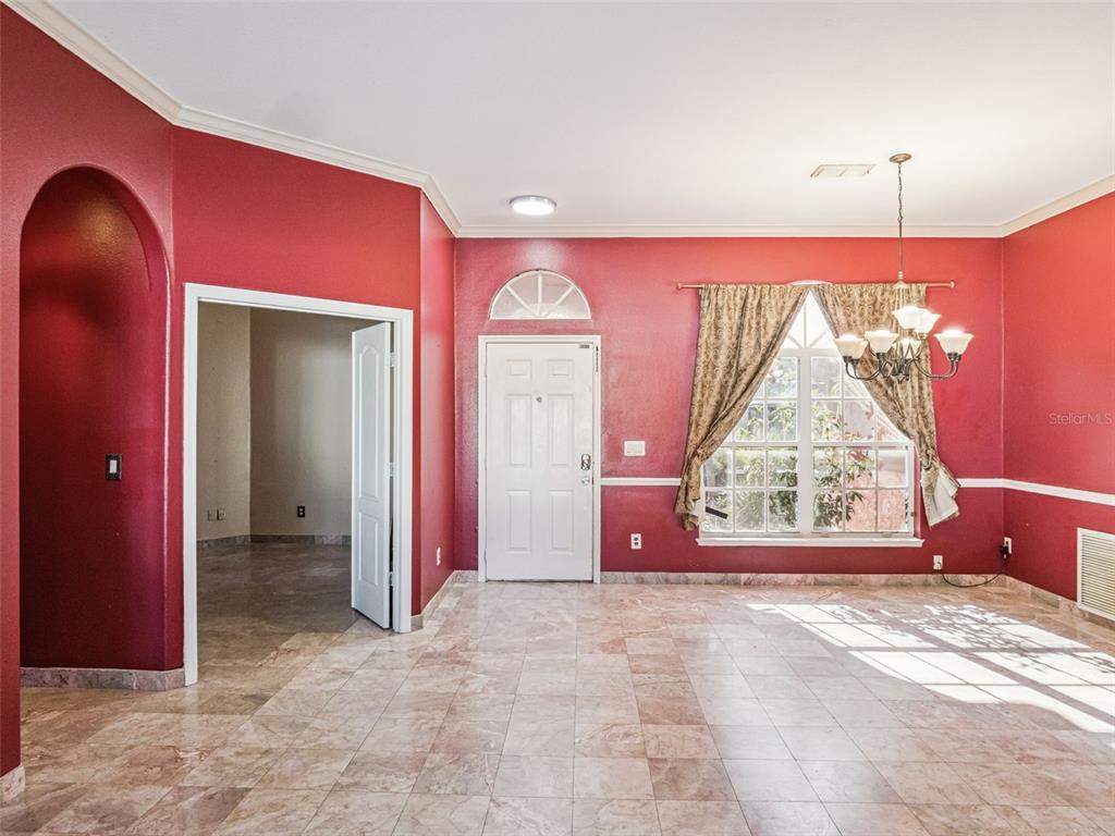 9101 Lake Coventry Court Gotha, FL 34734 - Photo 2 of 45 an empty room with windows and a chandelier fan