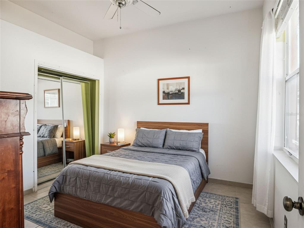 9101 Lake Coventry Court Gotha, FL 34734 - Photo 27 of 45 a bedroom with a bed and a refrigerator